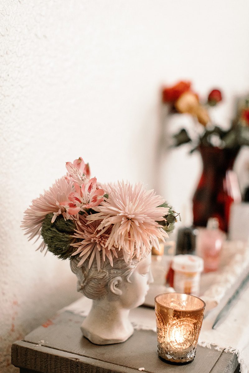 flowers in a ceramic head vase studio apartment wit & delight