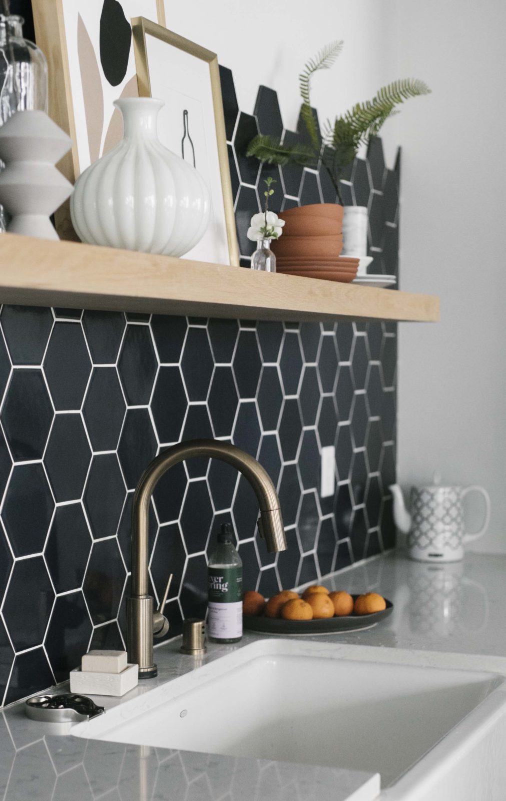 faucet and sink with modern tile backsplash in a kitchen