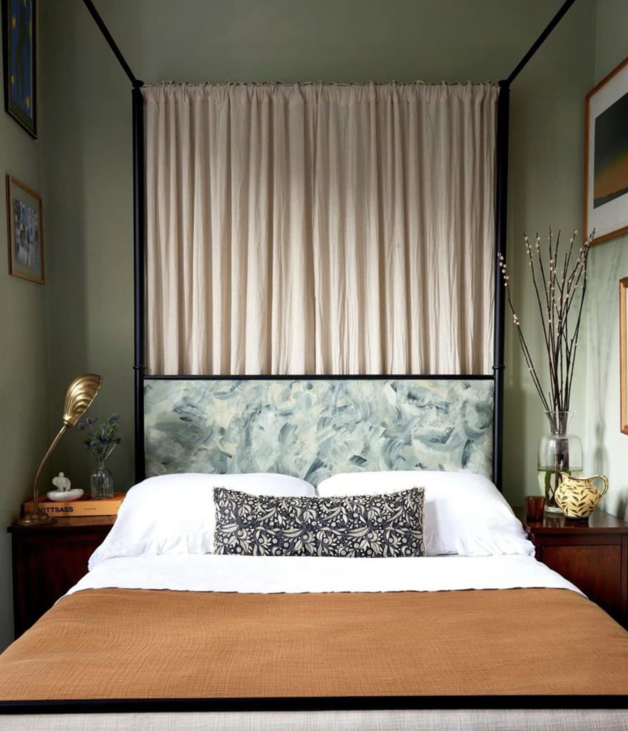 Serene bedroom with a curtain behind the headboard