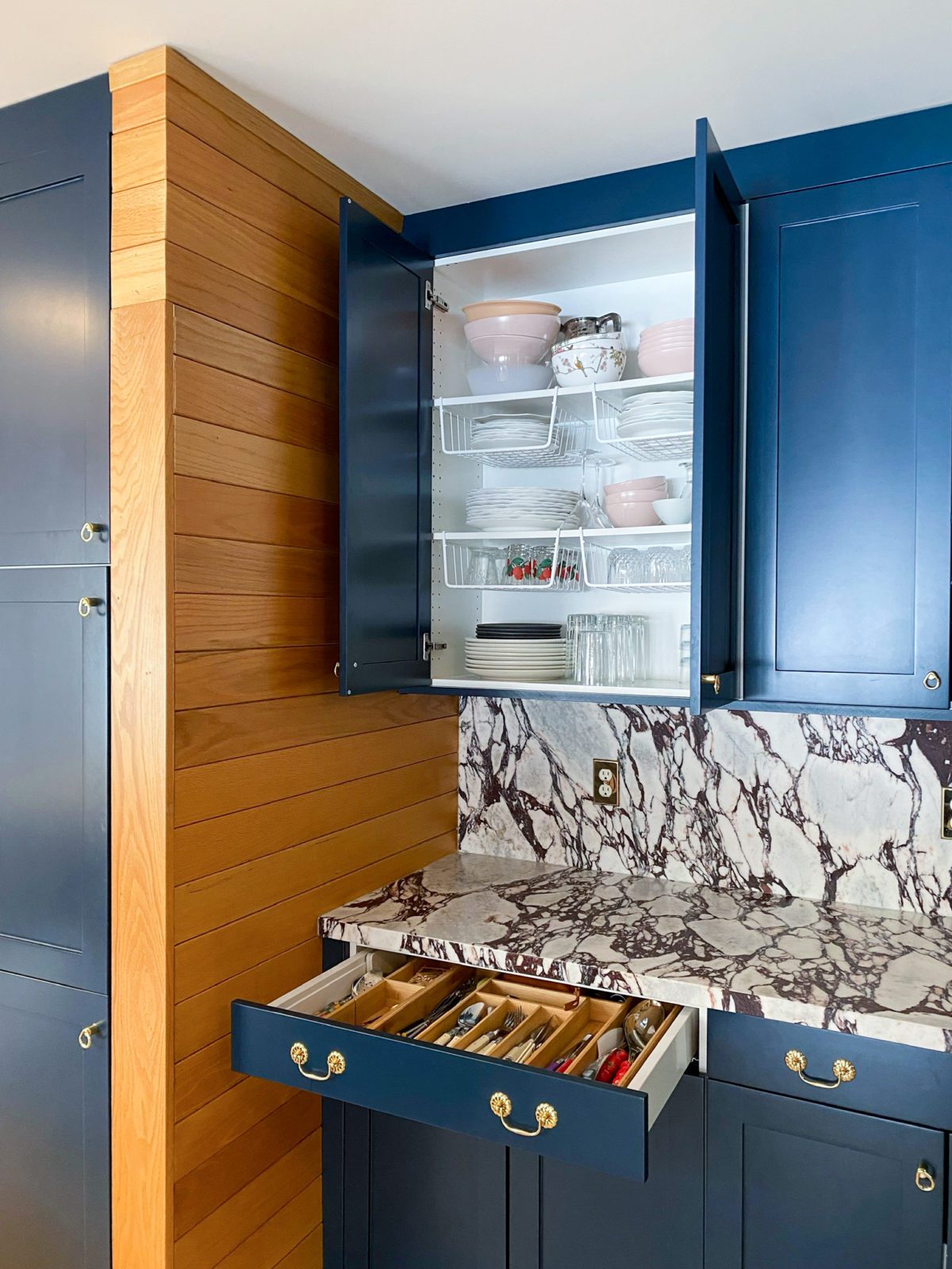 Kitchen cabinets and drawers from Boxi by Semihandmade are open to reveal the storage capabilities and what's inside. 