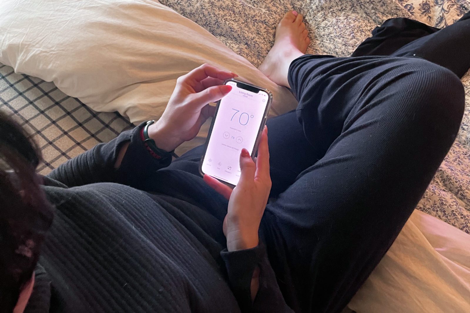 Woman sitting on a couch using an app on her phone.