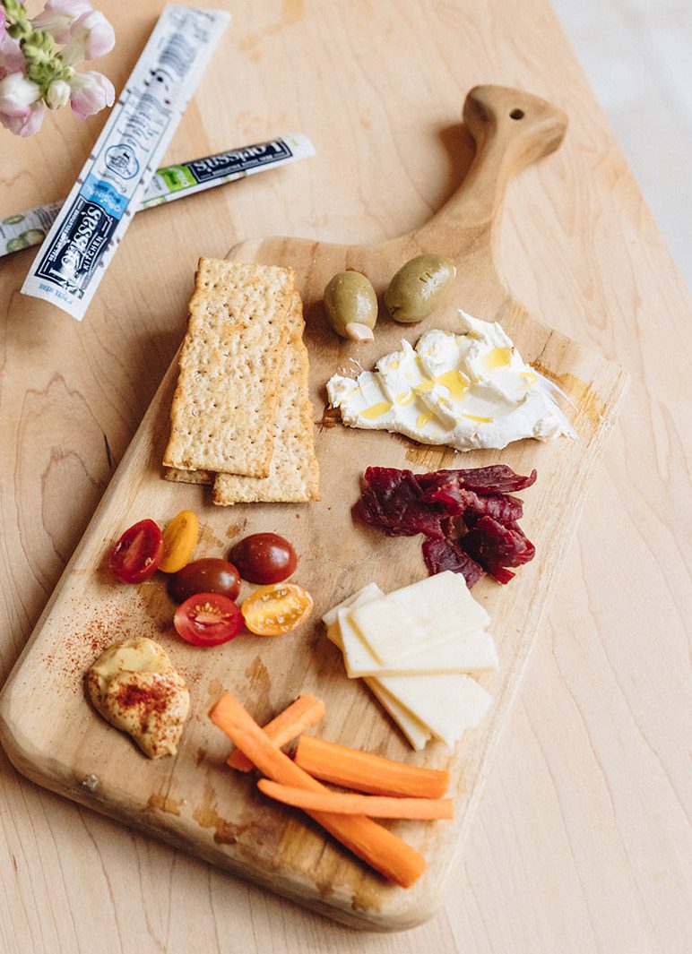 Snack plate with savory snacks, vegetables, cheese, crackers