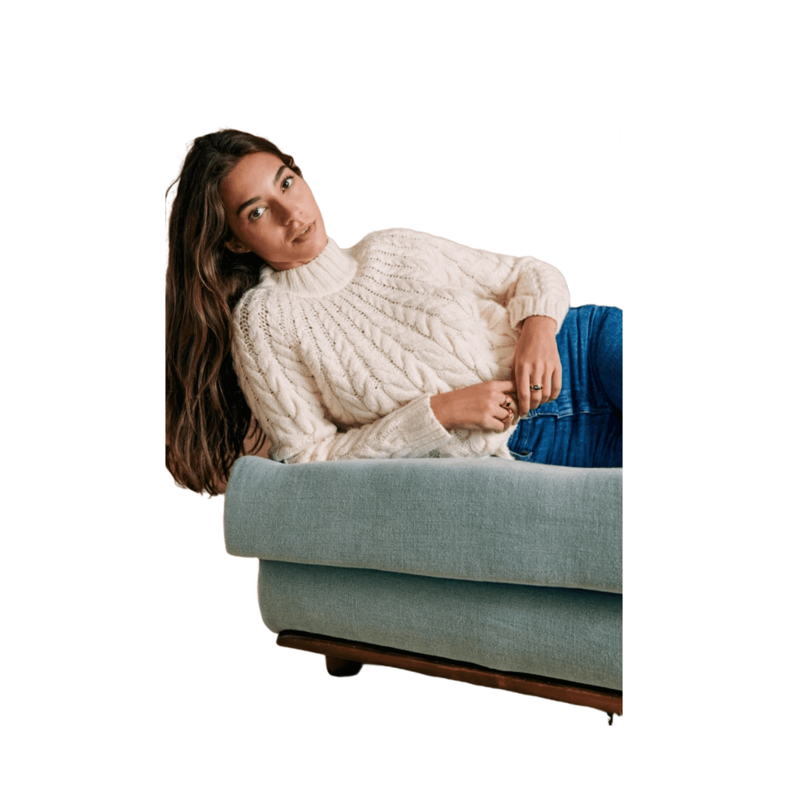 woman lying on a couch wearing a high-collared sweater