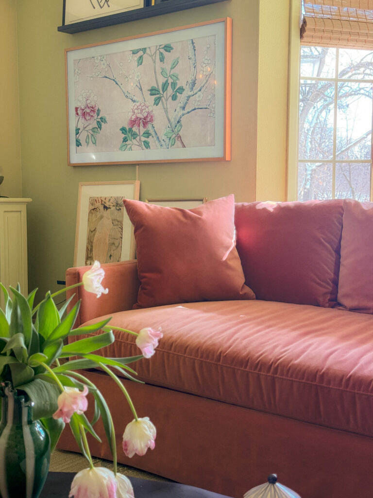 A pink sofa in a green family room
