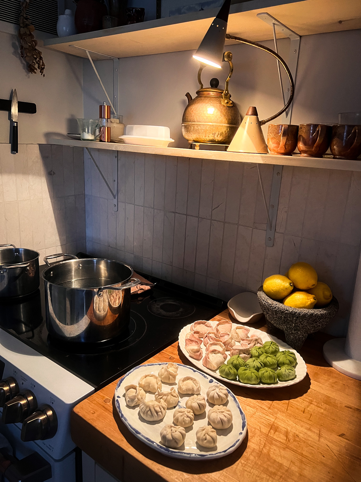 cooking dumplings at cookbook club in a cozy kitchen with butcher block countertops