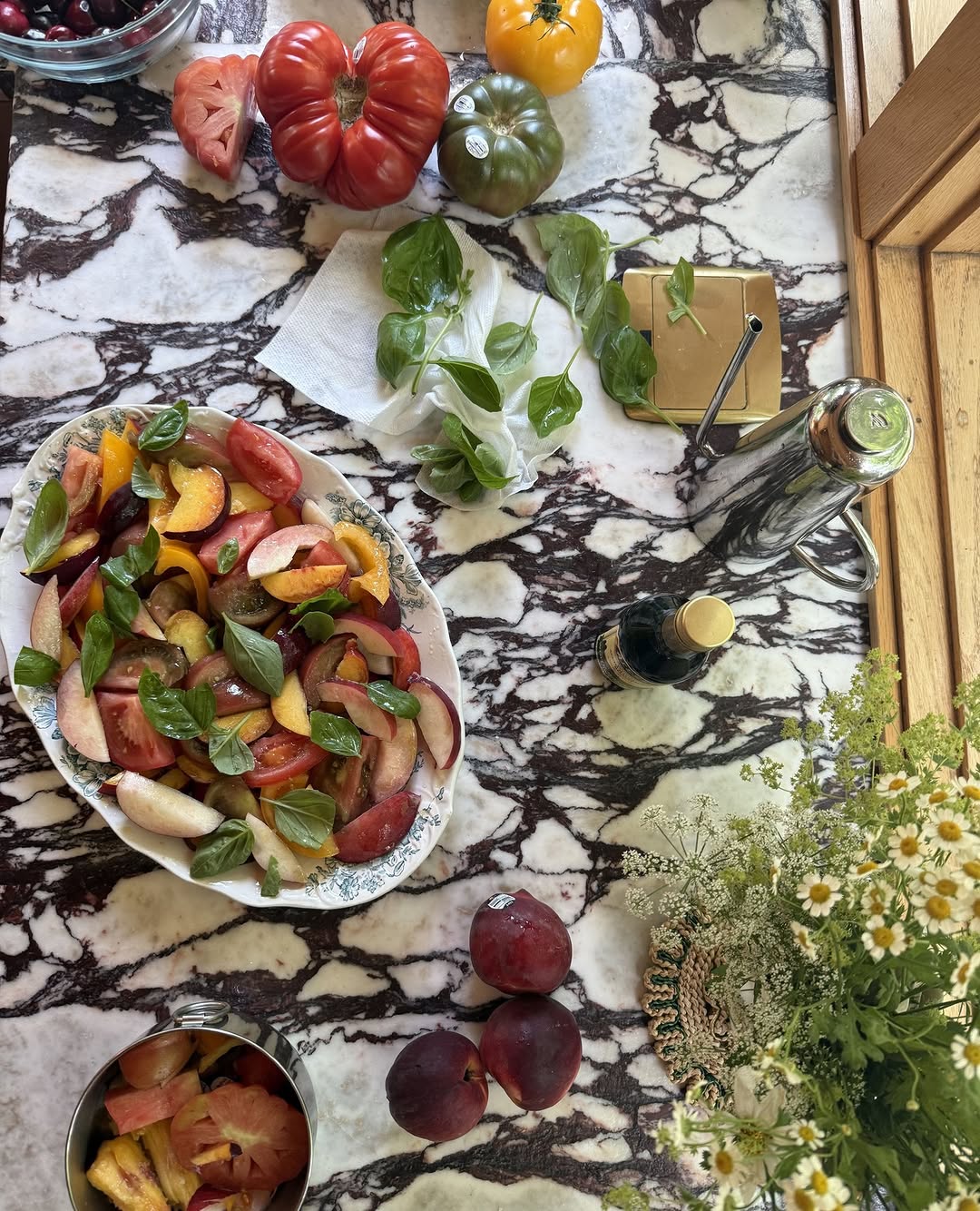 a peach and heirloom tomato salad on a serving dish at cookbook club