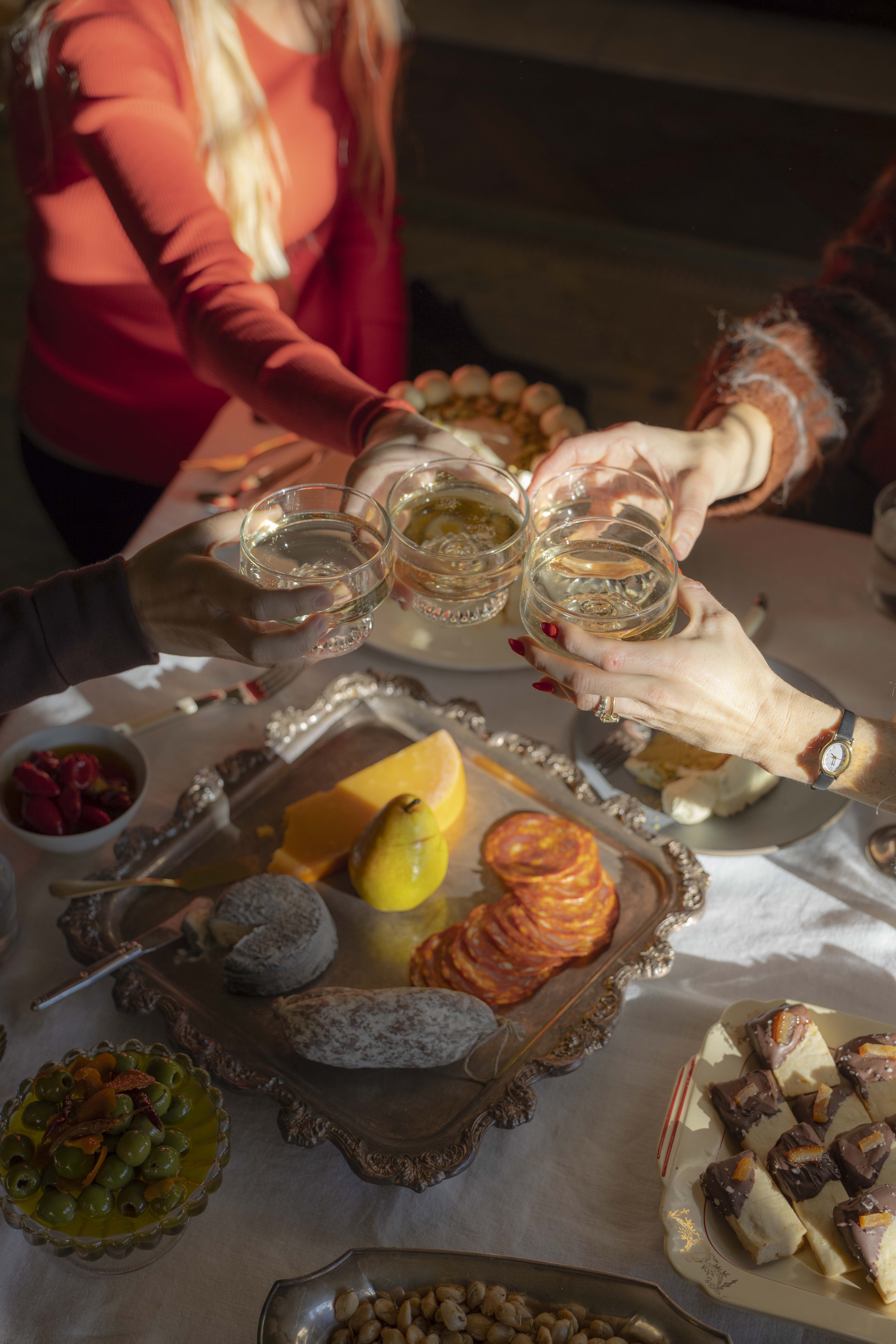 Four friends enjoy glasses of bubbly at an afternoon tea party